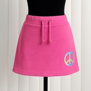 DELIA’S Catch My Vibe Terry Cloth Mini Skirt Holographic Peace Sign Pink Size M